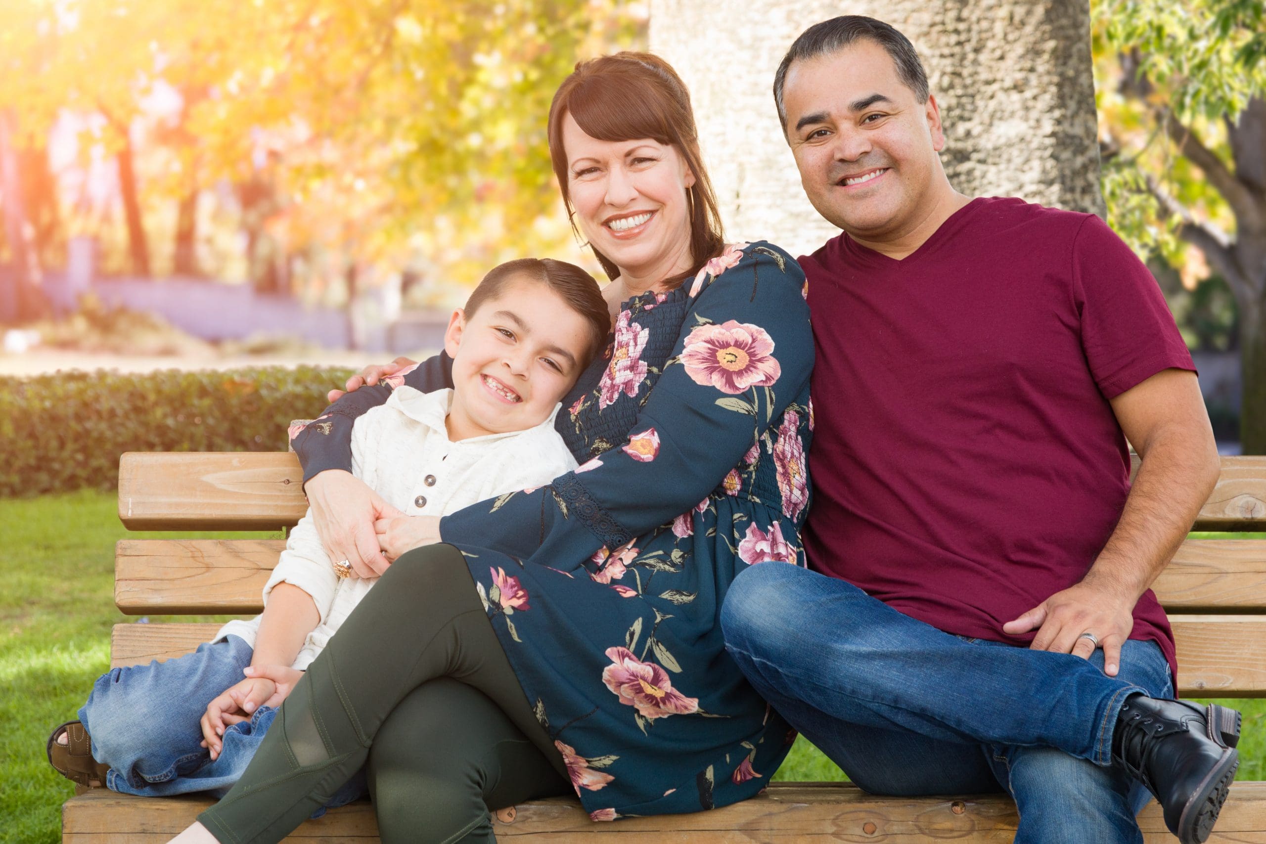 Parents sitting on bench with sons smiling
